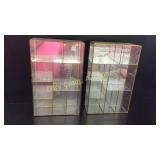 Two glass display cases both have broken glass
