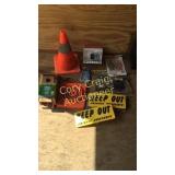 Keep out signs, poncho, orang cones, cedar bird
