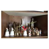 Shelf of Homco figurines, bells, candle holder
