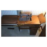 Singer sewing machine in cabinet
