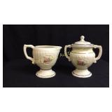 Tall glazed ceramic sugar and creamer, delicate