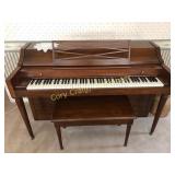 Baldwin spinet piano with bench and sheet music...