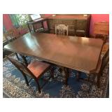 Large wooden dining table with four chairs
