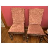 Two wooden chairs with covers have damage
