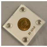1906 five dollar gold coin with crested eagle on