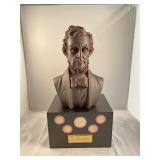Abraham Lincoln bust on box with coins