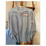 Three Ben Franklin employee smocks