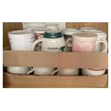 Coffee mugs on shelf in cabinet above the stove