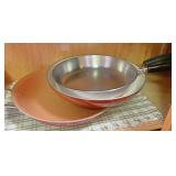 Set of fry pans on top shelf