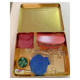 Tin Of compacts and other beauty supplies