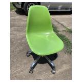Green plastic rolling chair