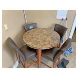 Round kitchen table with four tall chairs
