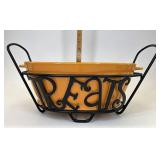 Wrought iron treats with orange pottery bowl