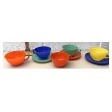 Colorful glass cups and saucers