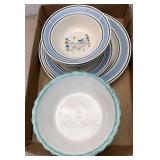 Bowls with teal trim and blue primitive plates