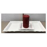 White decorative plates with red sparkly candle