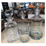 Three crystal decanters and glass