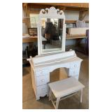 White vanity with wall shelf and stool