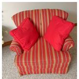 Red sofa chair with 2 throw pillows