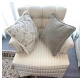 White chair with throw pillows