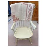White rocking chair with pink throw blanket