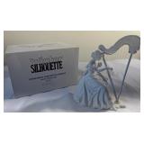Winter silhouette Christmas concerto harpist