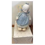 Precious moment doll in rocking chair