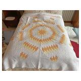 Yellow and orange star patchwork quilt