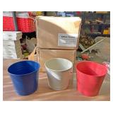 Two boxes of decorative buckets