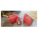 Three red plastic gas cans