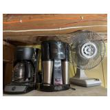 Two coffee makers and a fan