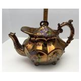 Lusterware teapot repairs have been made