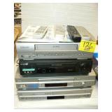 STACK OF VCRs AND REMOTES