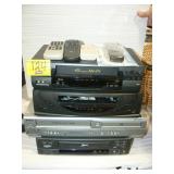 STACK OF VCRs AND REMOTES