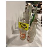 2 ROWS OF ANTIQUE GLASS SODA BOTTLES