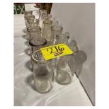 2 ROWS OF ANTIQUE GLASS MILK BOTTLES OF ALL KINDS