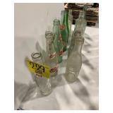 2 ROWS OF ANTIQUE GLASS SODA BOTTLES