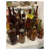 GROUP OF AMBER & GREEN GLASS BOTTLES OF ALL KINDS