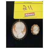 2 GOLD-TONE CAMEO BROOCHES - ONE IS WEARING A