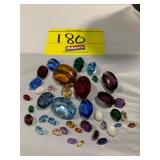 GROUP OF OVAL FACETED GEMSTONES OF ALL COLORS