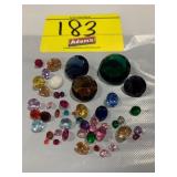 GROUP OF ROUND FACETED GEMSTONES OF ALL COLORS