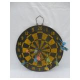 Antique dart board with darts.