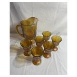 Carnival glass pitcher and 6 glasses