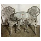 Glass top patio table with two chairs