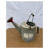 Metal watering can with wooden handle