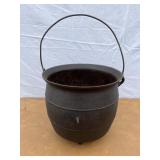 Cast iron footed kettle marked L8 on the bottom.
