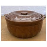 Stoneware casserole dish with lid. Has some chips.