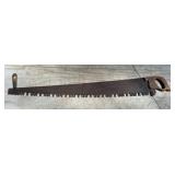 Old Warranted Superior logging saw with helper