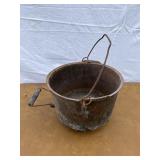 Cast iron footed kettle with handle on the side. M