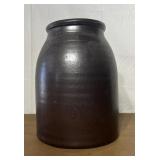 Large brown stoneware crock. Has large chip on the